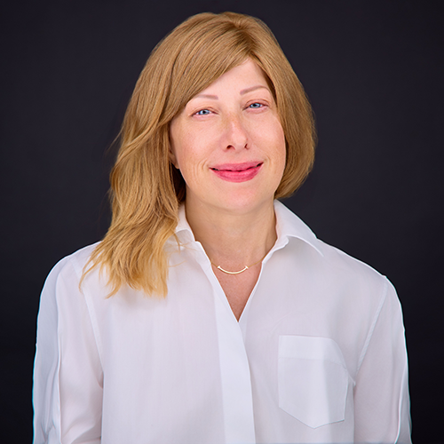 Alexandra Flynn in white shirt and hair past shoulders